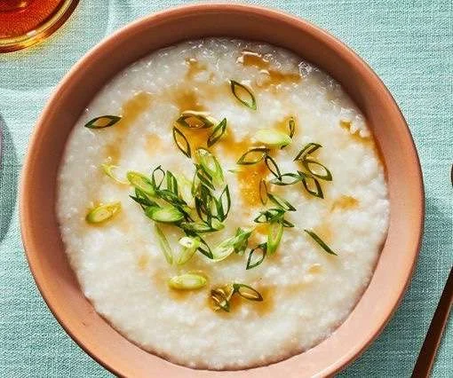 Chinese rice porridge with spring onions and a dash of soya sauce