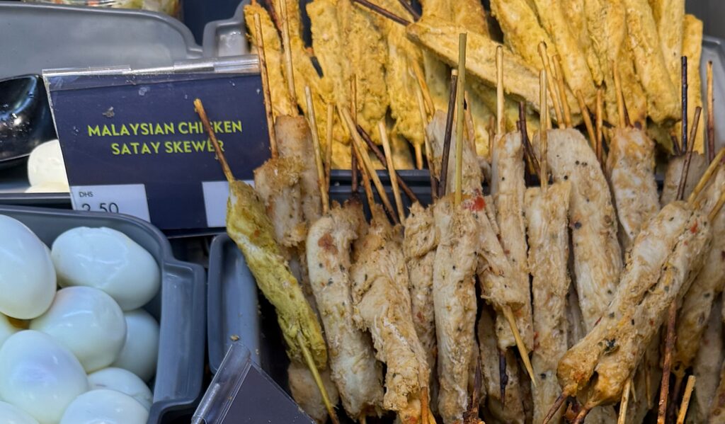 Not satay but long strips of marinated meat on skewers